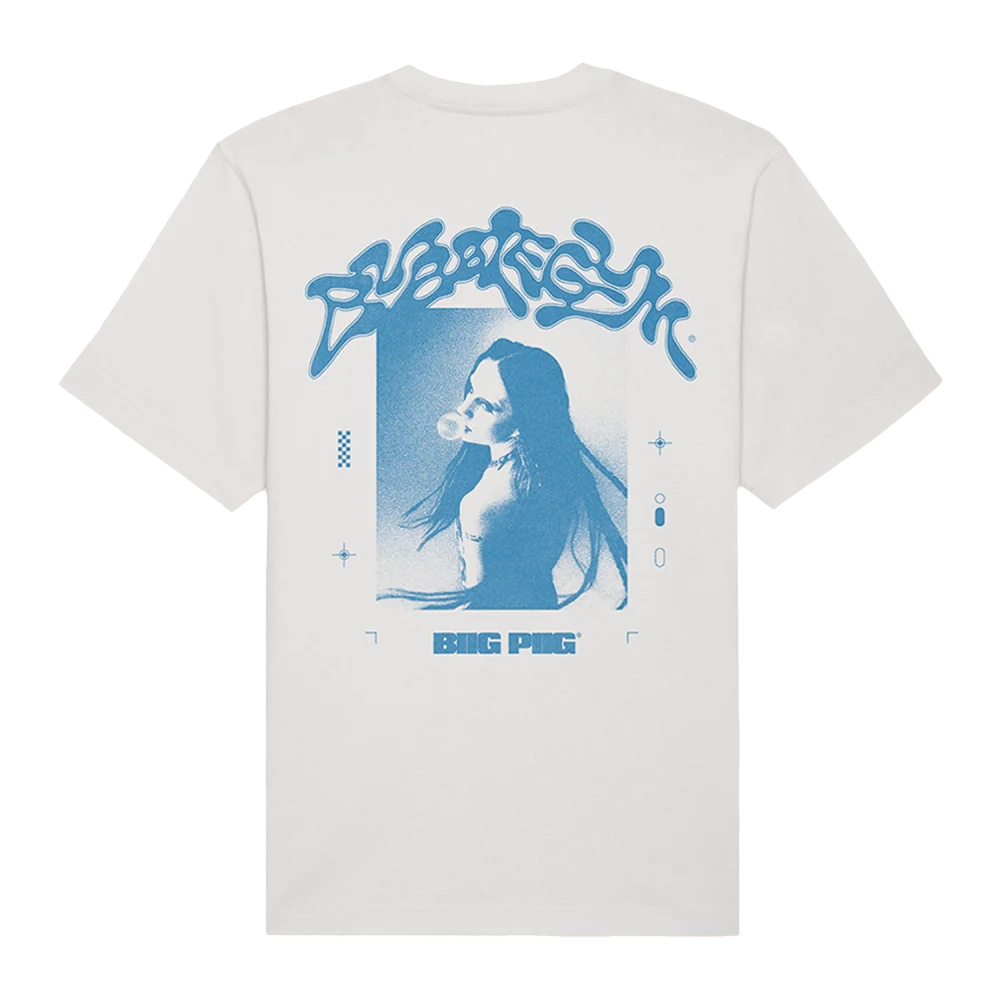 Back view of a white unisex T-shirt displaying a blue-toned photo of Biig Piig blowing bubblegum. ‘Bubbelgum’ appears in a bold, stylised font above, with ‘BIIG PIIG’ in smaller bold text beneath, and graphic stars framing the design.