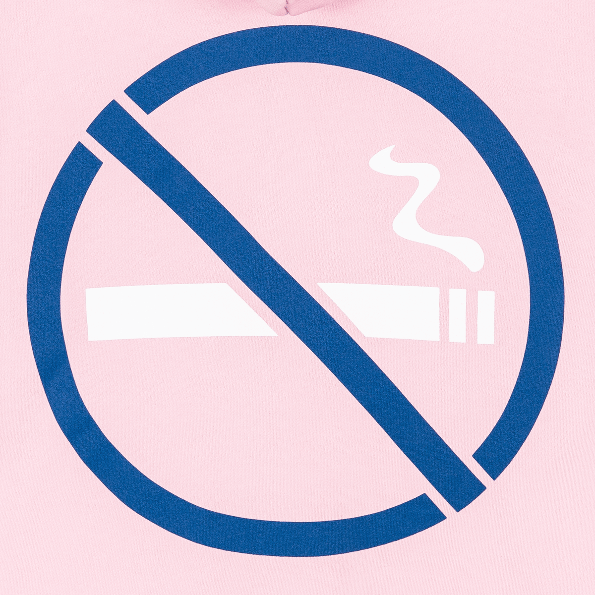 A close-up of a light pink garment featuring a large navy blue and white 'no smoking' symbol printed on the front.