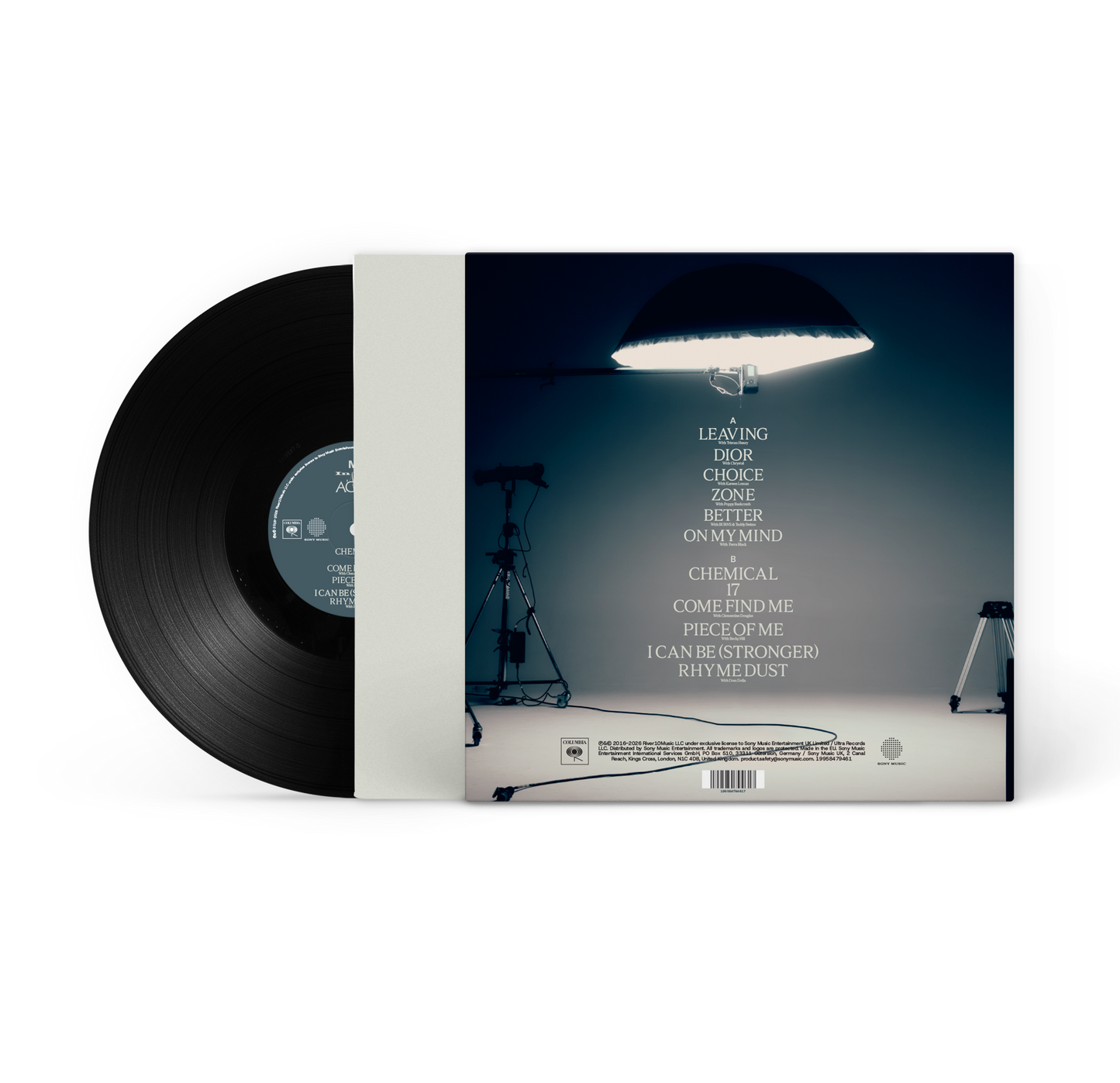 MK - In The Night Again - Vinyl. A vinyl record partially pulled from its sleeve, showing the black record and the back cover artwork with a studio scene and track list on a white background.