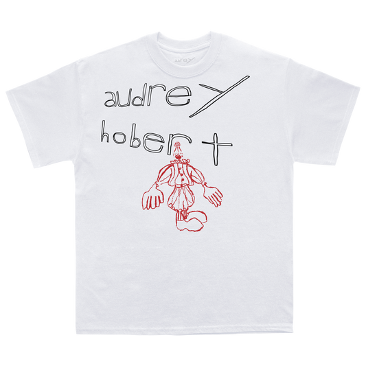 Front view of a white t-shirt with 'Audrey Hobert' text and red doodle-style clown graphic 