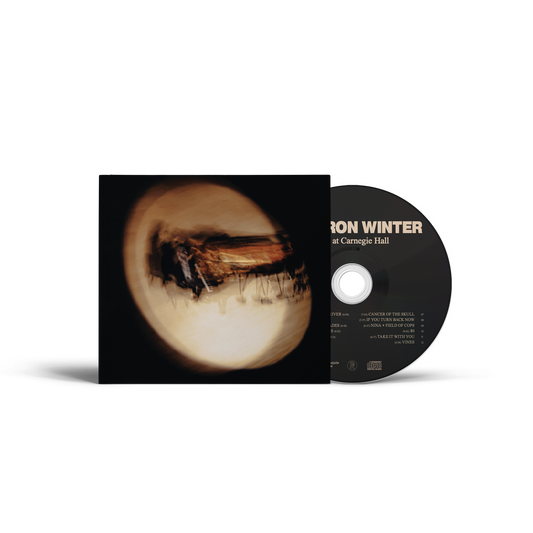 Cameron Winter's Live at Carnegie Hall CD. A CD album by Jon Winter titled 'Dark at Carnegie Hall' shown with its black sleeve and black disc.