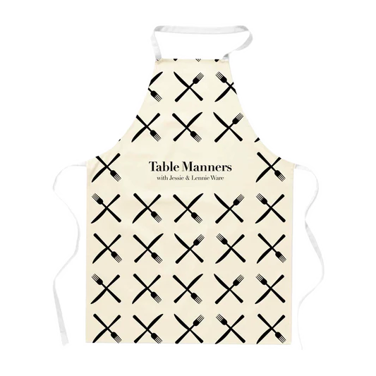 Table Manners natural apron with black knives and forks repeated front print