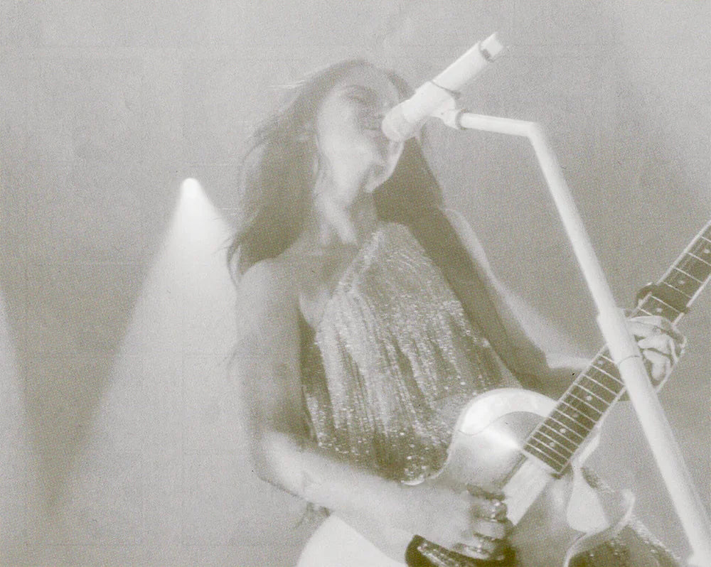 Black and white image of Maren Morris playing live in concert