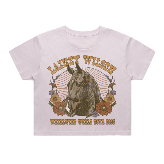 White cotton t-shirt featuring a vintage-style graphic of a horse surrounded by flowers and the text ’lainey wilson’ above and ’whirlwind world tour 2023’’ below.